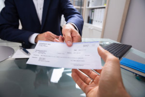 Employer hands over a check to his subordinate